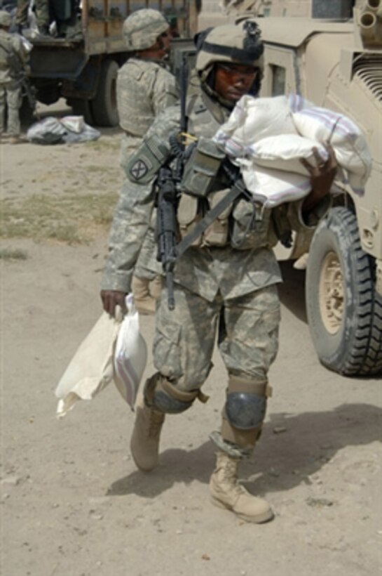 U.S. Army soldiers unload supplies from a truck during a humanitarian aid mission in the Ghazni province of Afghanistan on Sept. 20, 2006.  The soldiers are attached to Delta Company, 2nd Battalion, 4th Infantry Regiment, 10th Mountain Division.  
