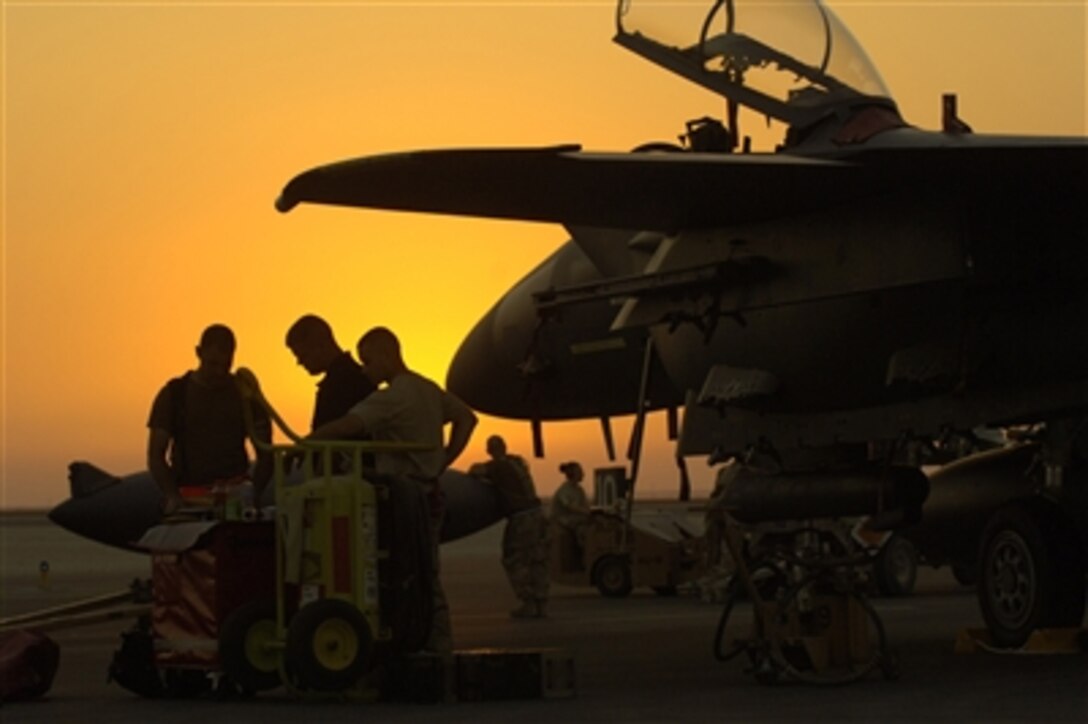 Airmen from the 494th Aircraft Maintenance Unit, Lakenheath Royal Air Force Station, perform post-flight inspections on an F-15 Strike Eagle, from the 494th Fighter Squadron, at an undisclosed location in Southwest Asia, Sept. 21, 2006.