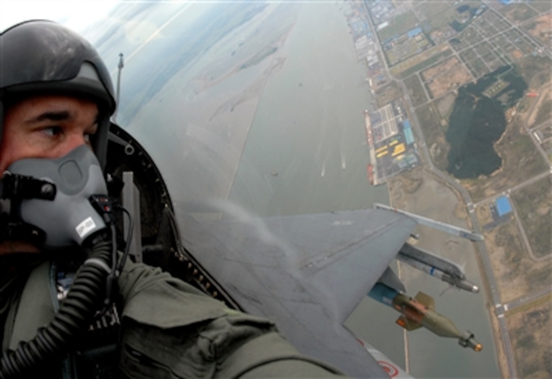 U.S. Air Force photographer Senior Airman Sean Sides sits in the back seat of an F-16D Fighting Falcon aircraft during a training flight over Kunsan Air Base, South Korea, Sept. 18, 2006. 