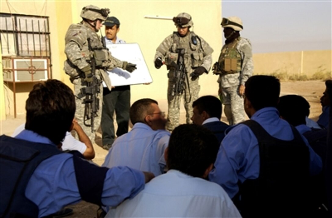 U.S. Army soldiers from Charlie Company, 2nd Battalion, 35th Infantry Regiment, 25th Infantry Division, teach Iraqi police officers how to set up checkpoints during a training mission in Kirkuk, Iraq, Sept. 25, 2006. 