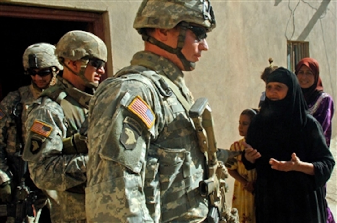 U.S. Army soldiers from Apache Troop, 2nd Squadron, 9th Cavalry Regiment, exit a home after searching it for weapons and conrtraband during a cordon and search mission in Muqdadiyah, Iraq, Sept. 20, 2006. 
