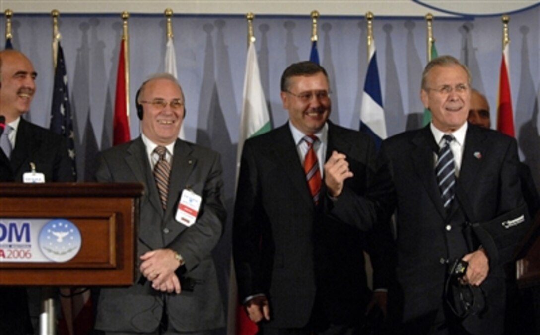 Defense Secretary Donald H. Rumsfeld, right, jokes with members of the press during the Southeastern Europe Defense Ministerial press conference in Tirana, Albania, Sept. 27, 2006. Rumsfeld is visiting Albania to recognize and encourage its continuing efforts to join NATO and to thank its troops for their service in Iraq and Afghanistan. 