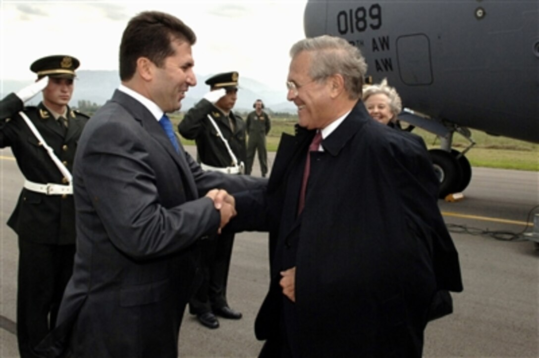 Albanian Minister of Defense Fatmir Mediu (left) greets Secretary of Defense Donald H. Rumsfeld as he arrives at Tirana, Albania, on Sept. 26, 2006.  Rumsfeld is in Albania to attend the South Eastern European Defense Ministerial, and to encourage Albania's continuing efforts to join NATO.  