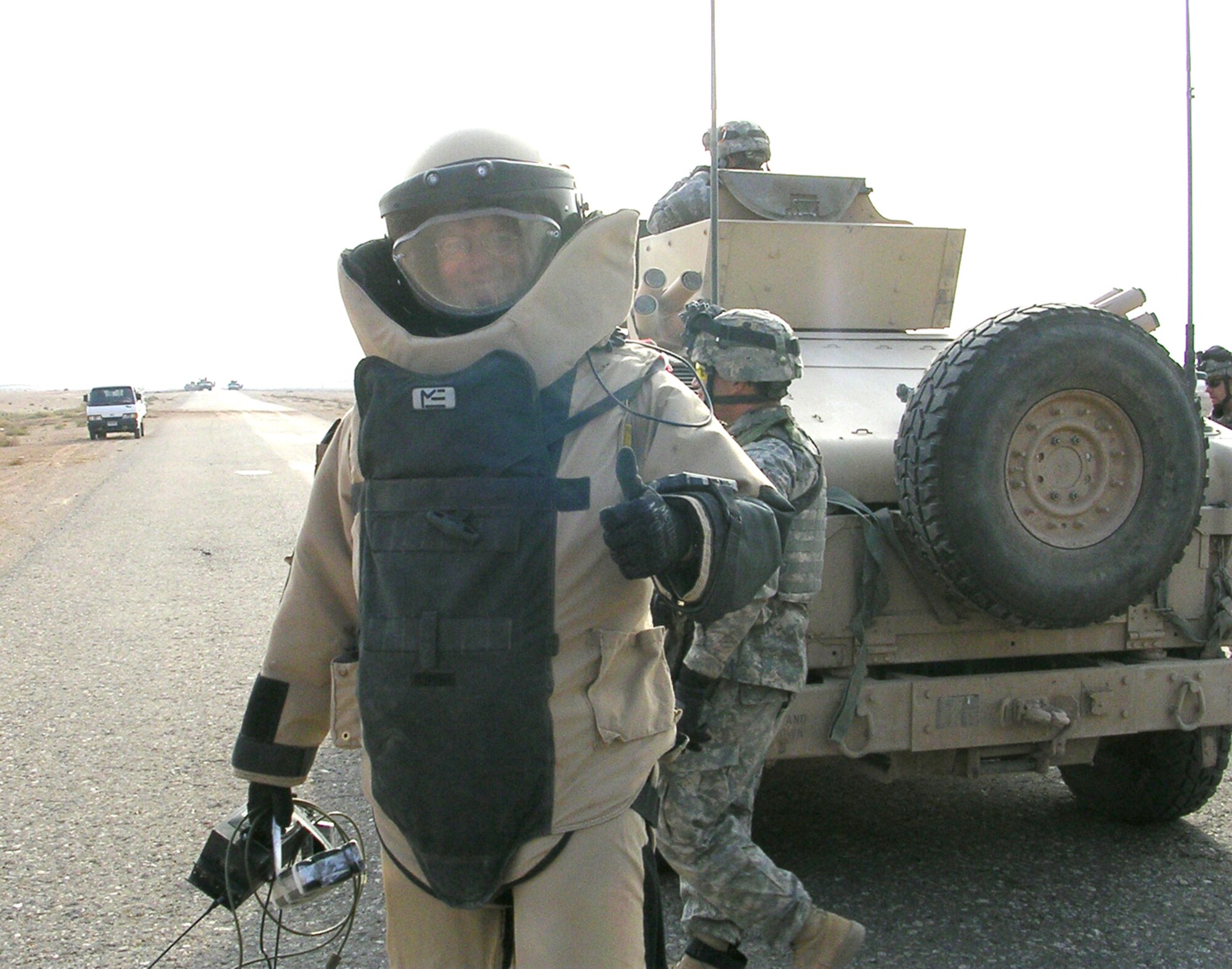 Tech. Sgt. Rik van de Pol, 347th Civil Engineer Squadron NCO in-charge of the Explosive Ordnance Disposal flight, gives a thumbs-up as he prepares to investigate a post-blast site north of Jisr Naft, Iraq, Dec. 6, 2005. Sergeant van de Pol was recently awarded the Bronze Star. (U.S. Army photo by Lt. Col. Arthur Kandarian)