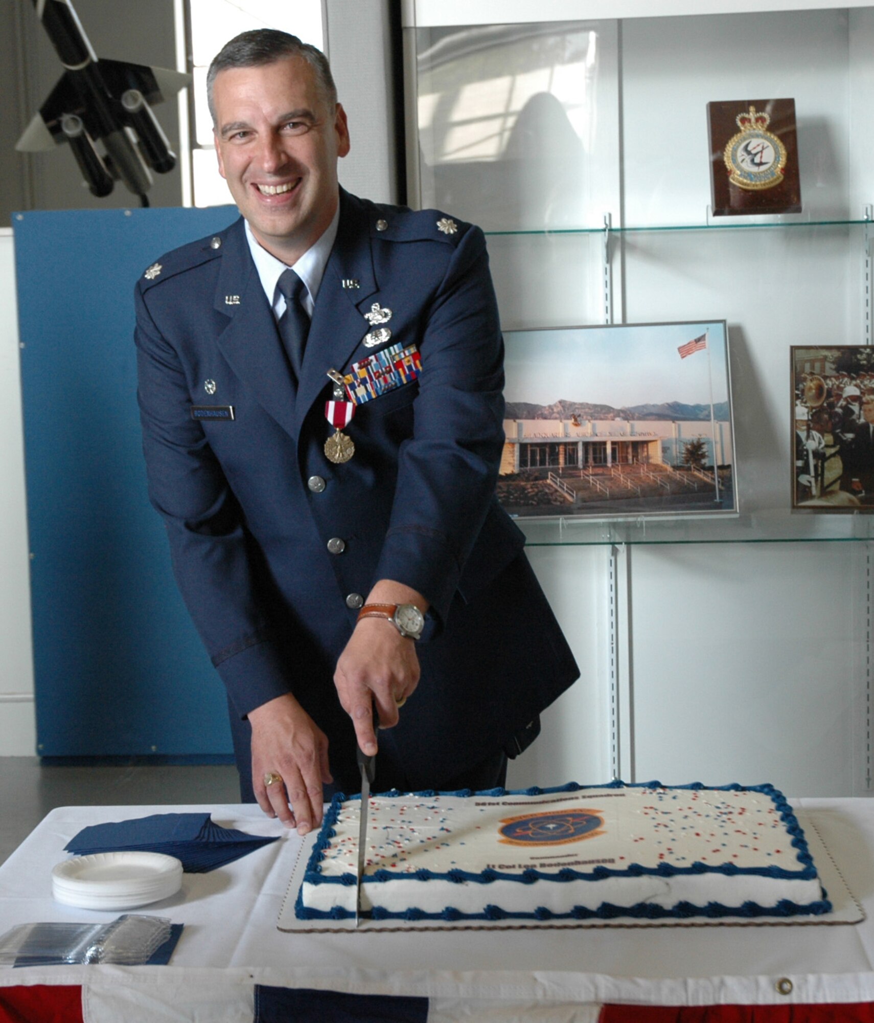 Lt. Col. Lee Bodenhausen, 561st Communications Squadron commander, cuts a cake during a reception celebrating the stand up of the 561st CS and his assumption of command Sept. 15 at the Peterson Air and Space Museum.
Photo by Senior Airman Jessica Switzer 060915-F-1467S-051 561st