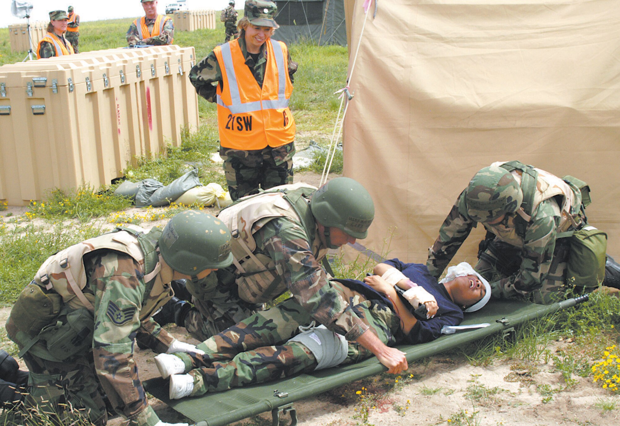 Condor Crest 06-06 Expeditionary Readiness Exercise was held Aug. 25 and 28 at Pete East. Here, Airmen practice self aid and buddy care following a mortar attack.
Photo by Joe Fischer
060828-F-0598F-002 Condor Crest 