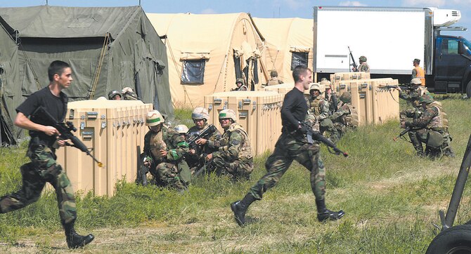 Aggressors "attack" Pete East Aug. 28 during Condor Crest, as the players practice their response to an attack. Blank rounds were used during the exercise for the first time this year. The training the Airmen receive during Condor Crest exercises is put to the test during deployments.
Photo by Joe Fischer
060828-F-0598F-001 Condor Crest