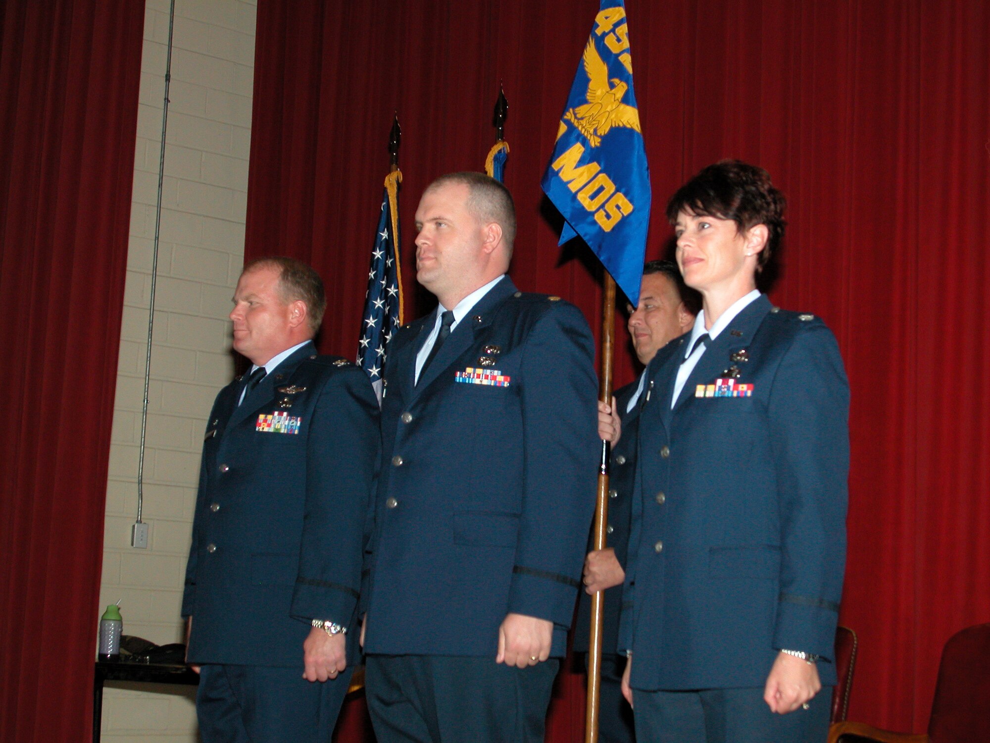 MARCH AIR RESERVE BASE, Calif. - Colonel Cam J. LeBlanc (left), 452nd Maintenance Group commander, conducted two change of command ceremonies recently. The first saw Lt. Col. Christine B. Schlacter (right), relinquish command of the 452nd Maintenance Operations Squadron to Maj. Aaron J. Heick (center). During the second, Lt. Col. Schlacter took command of the 452nd Maintenance Squadron. (U.S. Air Force photo by Tech. Sgt. Mike Blair, 452nd AMW/PA)

