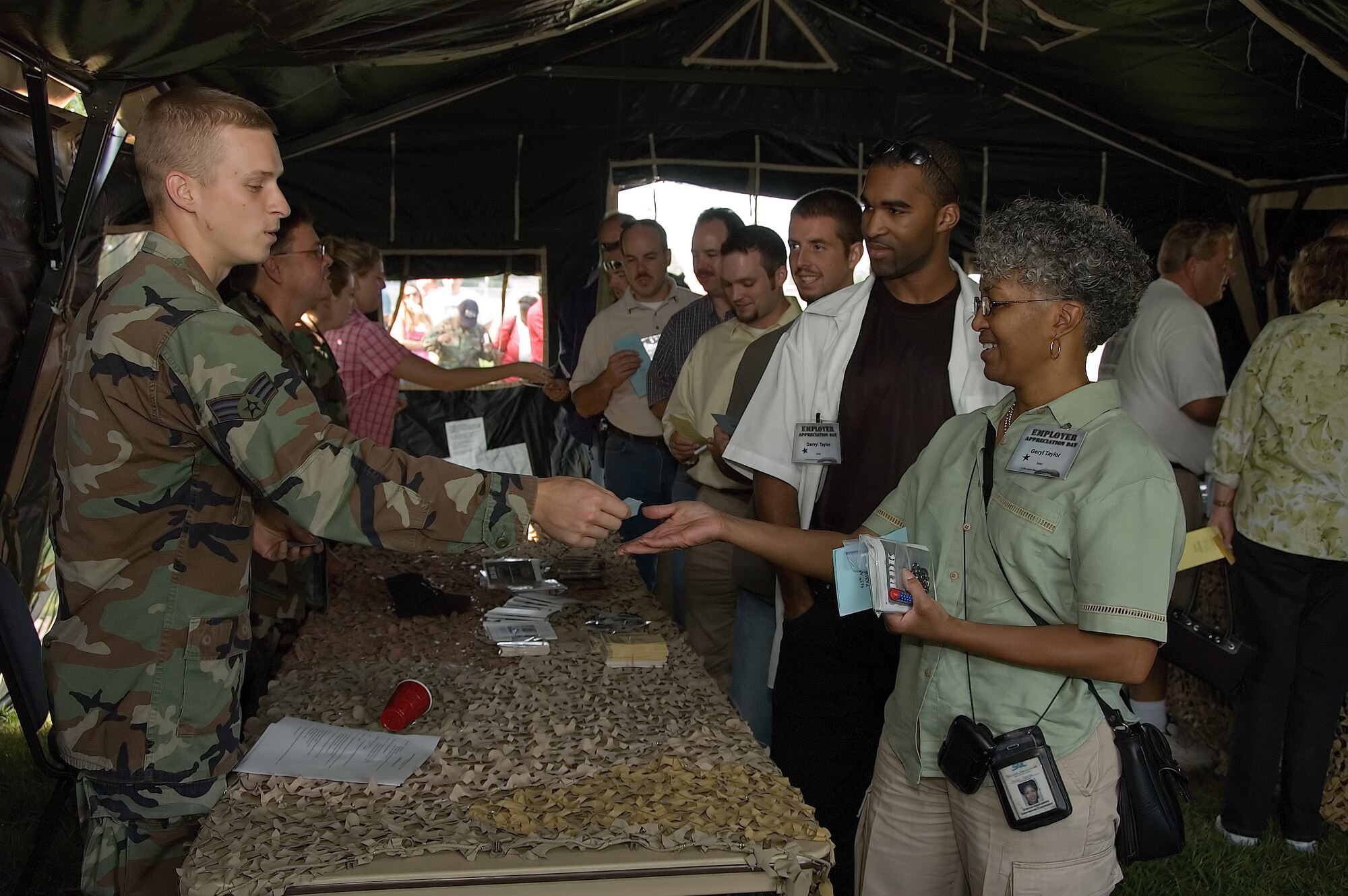 Senior Airman Joshua Runkles, 512th Airlift Wing Judge Advocate Office, processes Geryl Taylor, a maintenance supervisor with Science Applications International Corporation, through a mobility line as part of the 512th AW Employer Appreciation Day Sept. 9. Master Sgt. Daphnee Bennett-Jolley, 512th Logistics Readiness Flight, works at SAIC and nominated Ms. Taylor to attend the event. In all, 32 employers participated in the annual event, which gives employers the opportunity to experience Reserve life up close and in person. The 512th AW has more than 1,700 reservists assigned. Without the support of their employers, reservists would not be able to train and deploy to accomplish the Air Force?s vital role in the U.S. military. As part of the day, employers were ?mobilized,? and processed for a mock deployment through a simulated mobility line. They also received a tour of the base and an orientation flight on a C-5 Galaxy.