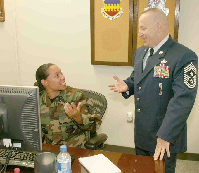 Chief Master Sgt. Gary Rutledge, 20th Fighter Wing command chief, discusses his daily schedule with Senior Airman Vanessa Duarte, 20th FW command chief's assistant, Tuesday. Chief Rutledge has a new edition added to his service dress. (U.S. Air Force photo/Senior Airman John Gordinier)