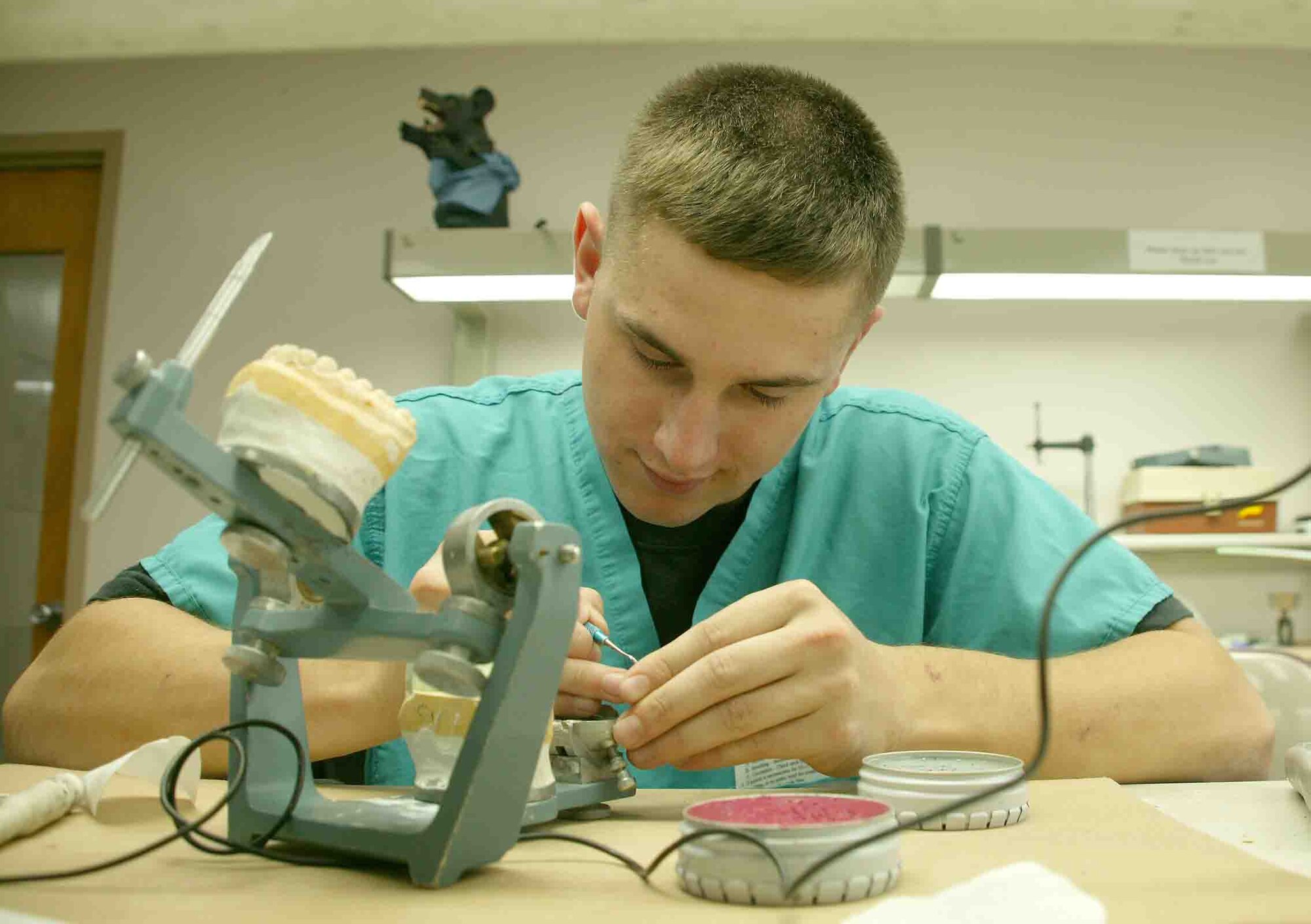 Airman 1st Class Zachery Alguire, 20th Aeromedical-Dental Squadron dental laboratory apprentice, adds some finishing touches to a dental prosthetic appliance. (U.S. Air Force photo/Senior Airman John Gordinier)