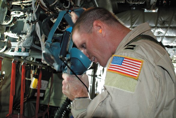Capt. Nathan Ferguson, 379th Expeditionary Aeromedical Evacuation Squadron, preflights an emergency oxygen mask. Captain Ferguson is deployed to Southwest Asia from the 43rd Aeromedical Evacuation Squadron. (U.S. Air Force photo/ Maj. Ann Peru Knabe) 