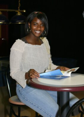 Tanya Ferriere was honored as the Pope Youth of the Year at the 2006 Kids Day celebration Sept. 16. Col. Timothy Zadalis, 43rd Airlift Wing commander, presented Ms. Ferriere with a plaque, a $500 savings bond and other prizes. (U.S. Air Force photo/Kelly Twedell)