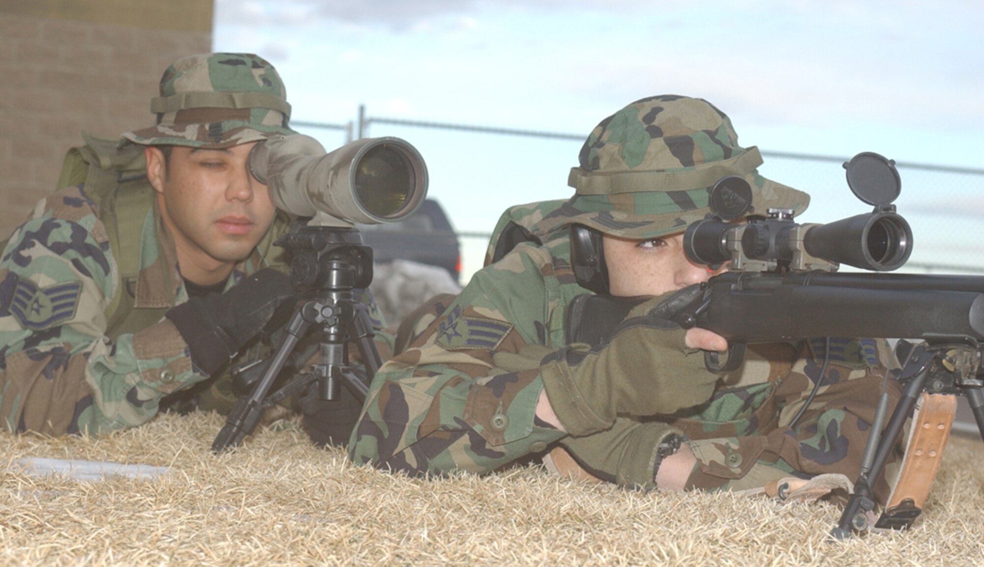 With the aid of his spotter Staff Sgt. Adam Martinez, left,  Senior Airman Steven Muir puts the sight of his M-24 sniper rifle on target. Both Airmen are members of the 741st Missile Security Forces Squadron's Tactical Response Force.