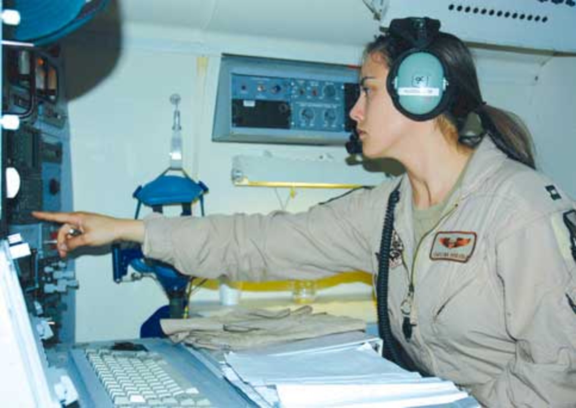 Capt. Christina Hodsden, 16th Expeditionary Air Command and Control Squadron navigator, makes adjustments during a night mission over the skies of Iraq. During the sortie, the JSTARS crew celebrated their 20,000th combat hour and saved four lives after a helicopter crashed into a lake. (U.S. Air Force photo/Senior Airman Tim Bazar)