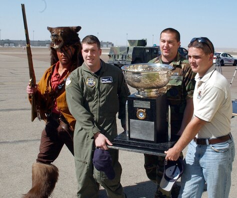 From left to right; 2nd Lt. Chris Dauer (a.k.a. "Grizz"), 341 MMXS, 1st Lt. Drew Woodbury, 341 OSS, Senior Airman Sam Jennings, 341 MMXS, and Airman First Class Christopher Stephens, 341 MSFS, escort the Blanchard Trophy from a C-17 onto a bus at the Great Falls International Airport Saturday.  All were members of the 2006 Malmstrom Guardian Challenge Team.    