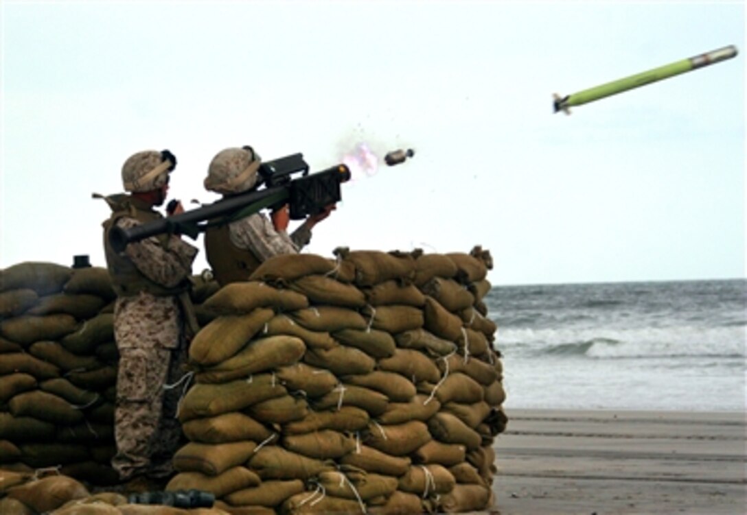 U.S. Marine Corps Staff Sgt. Tony L. Moore, left,  coaches a 2nd LAAD Marine as they fire a Stinger missile during training at Onslow Beach on Marine Corps Base Camp Lejeune, N.C., Sept. 13, 2006.

