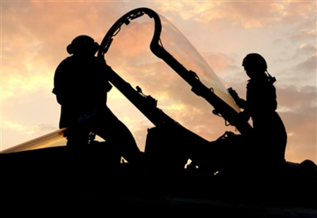 Captain trainees aboard the Nimitz-class aircraft carrier USS Dwight D. Eisenhower clean the canopy of an F/A-18C Hornet assigned to Strike Fighter Squadron 83 near Virginia Beach, Va., Sept. 26, 2006.