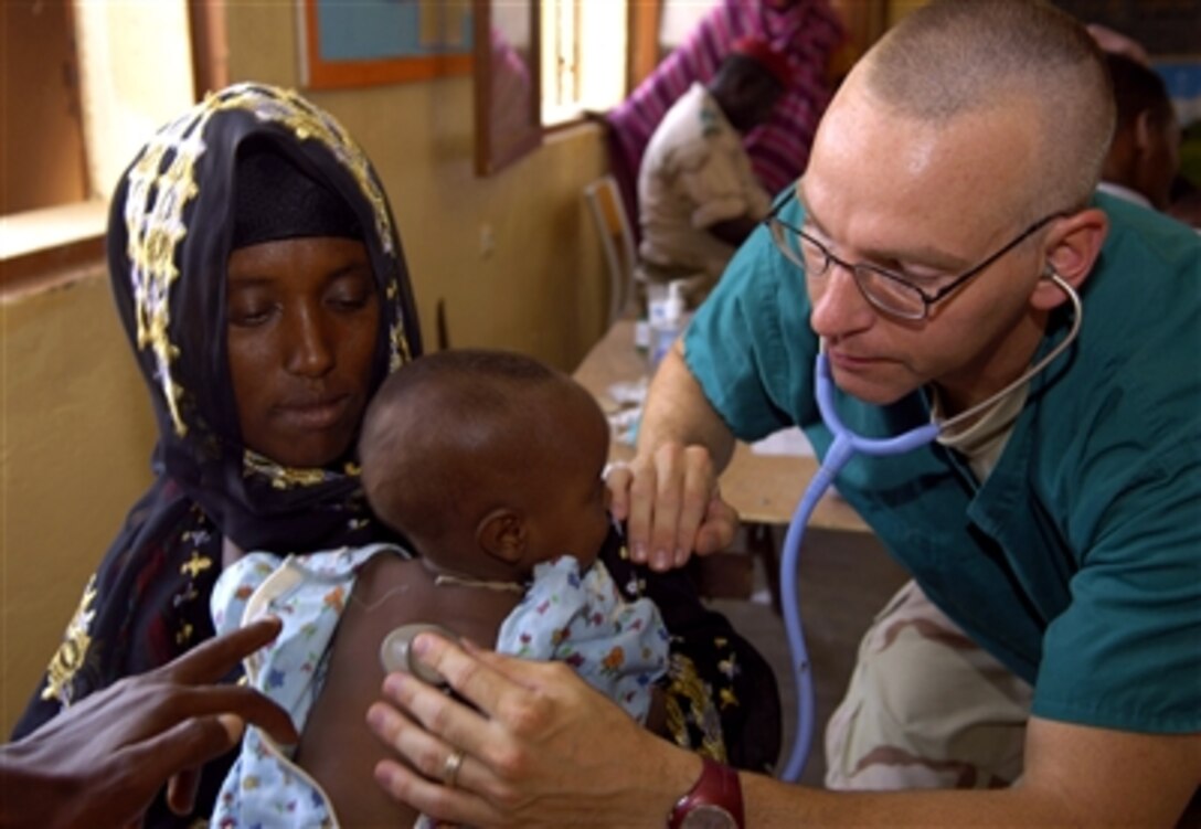 U.S. Navy Lt. Cmdr. Christopher Hults listens to the breathing of a patient during a medical civic action program in Ali Adde, Djibouti, Sept. 20, 2006, in support of Combined Joint Task Force - Horn of Africa. 