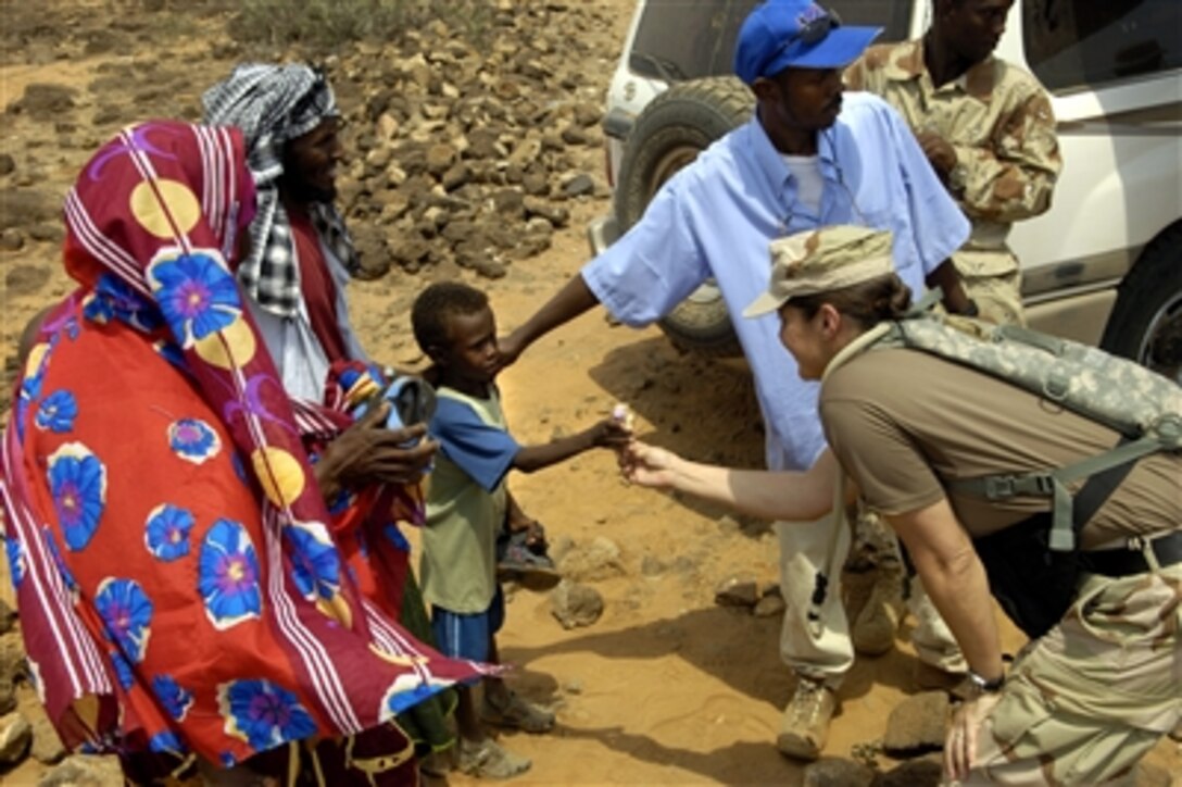 U.S. Navy Lt. Cmdr. Wendy Halsey hands out candy to local children during a medical civic action program in Guistir, Djibouti, Sept. 16, 2006, in support of Combined Joint Task Force - Horn of Africa. 