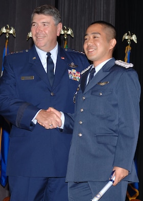 COLUMBUS AIR FORCE BASE, Miss. - General Paul V. Hester, commander Pacific Air Forces, congratulates Japan Air Self Defense Force 1st Lt Masakazu Kamimura, Kobe, Hyogo, Japan, after receiving his USAF silver wings.  General Hester addressed the Specialized Undergraduate Pilot Training Class 06-15 during a graduation ceremony.  He also met and spoke with local leaders. (Air Force photo by Senior Airman John Parie)