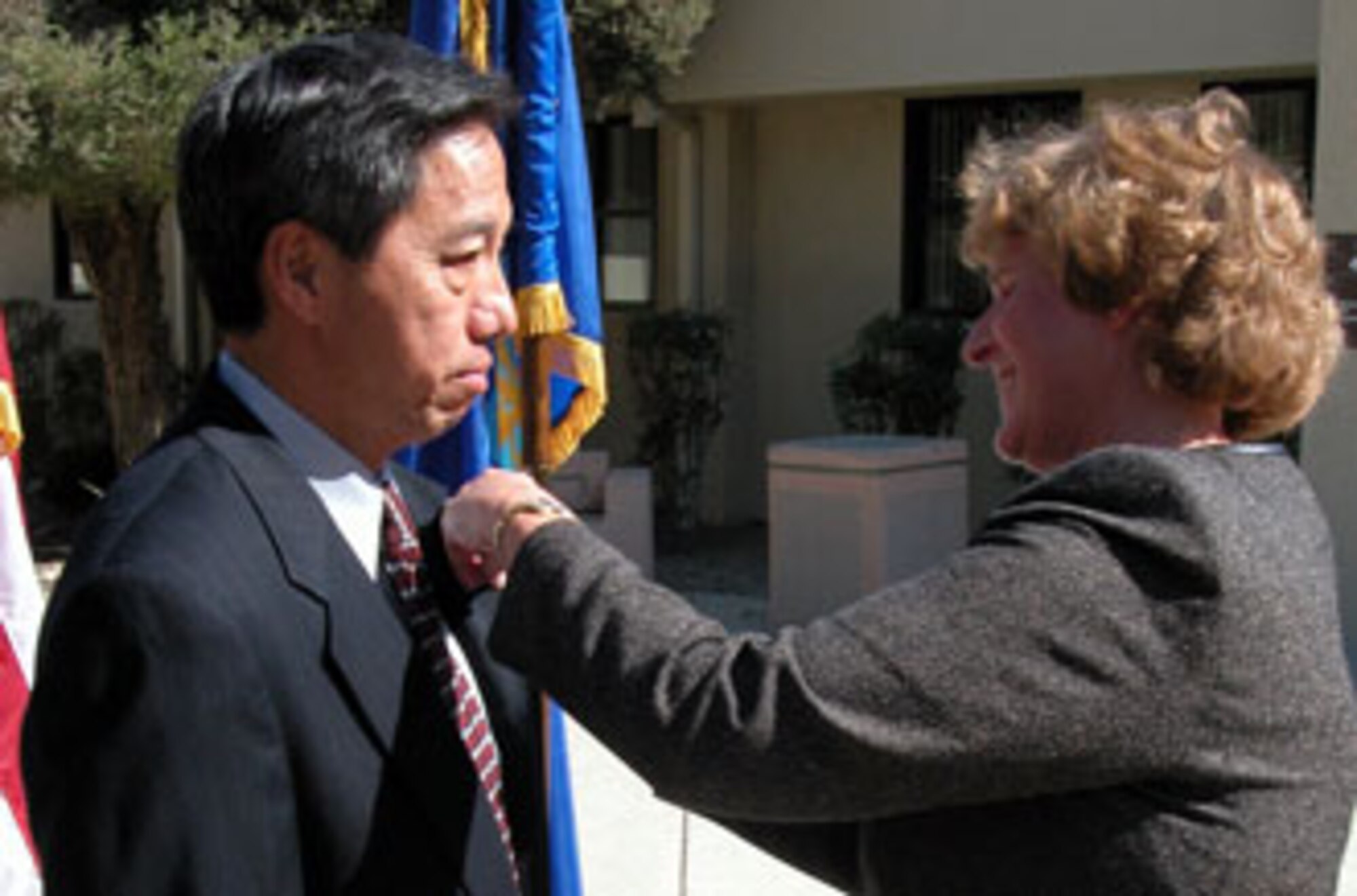 Assistant Auditor General of the Air Force Ms. Judy Simon promotes Mr. Derrick Wong, Air Force Audit Agency, March Air Reserve Base, Calif., to the rank of GS-15.  Ms. Simon promoted three local auditors to the highest GS grade during a recent ceremony at the base. (U.S. Air Force photo by Maj. Don Traud)