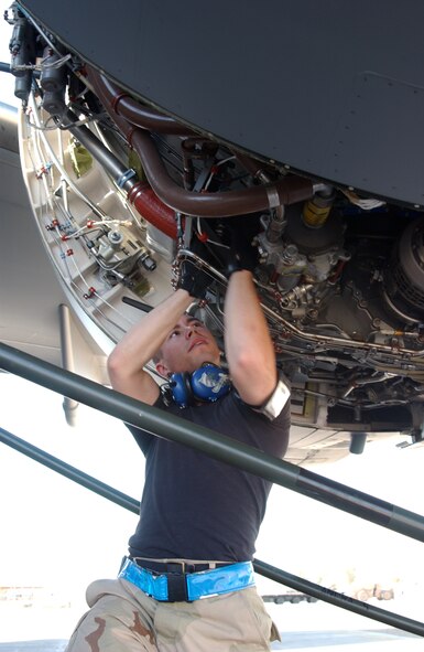 Airman 1st Class Mark Mano works on the engine of a C-17 Globemaster III Sept. 18 at Balad Air Base, Iraq. Airman Mano is assigned to the 721st Air Mobility Operations Group, Detachment 5. The Air Mobility Command detachment is responsible for the recovering, marshaling and repair of the C-5 Galaxies and C-17 that land here (U.S. Air Force photo/Senior Airman James Croxon)