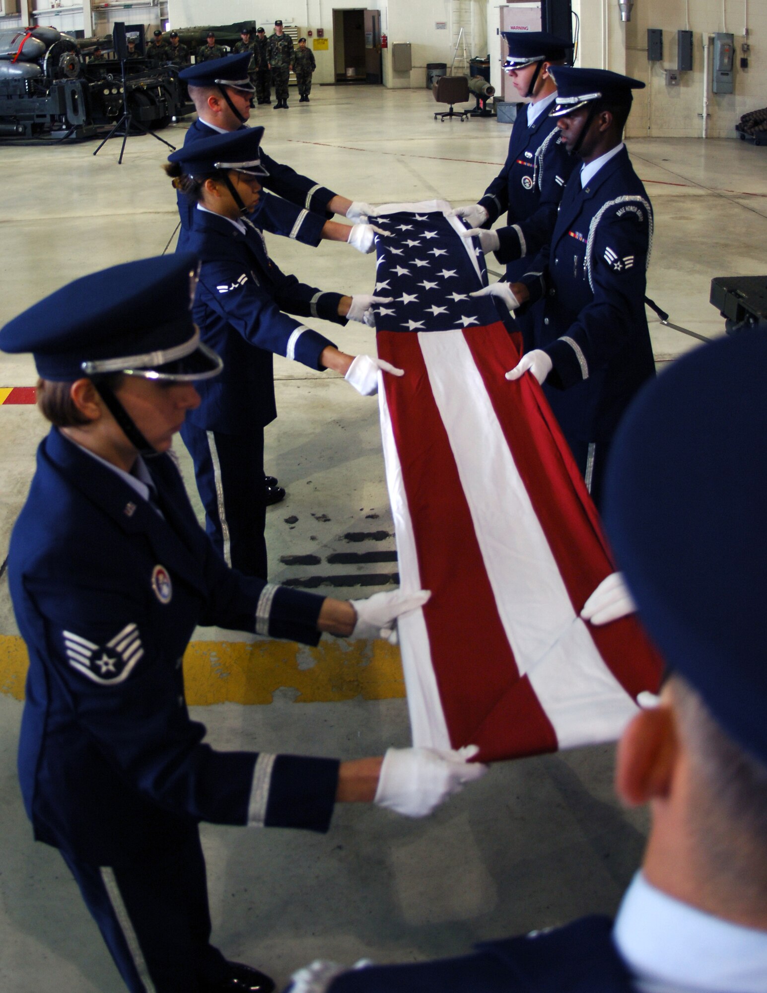 MINOT AIR FORCE BASE, N.D. -- Members of the base Honor Guard fold the U.S. flag in honor of servicemembers who have been captured as prisoners of war or are missing in action during a special retreat ceremony at Dock 7 Sept. 22. (U.S. Air Force photo by Airman First Class Joe Rivera)