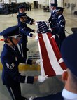 MINOT AIR FORCE BASE, N.D. -- Members of the base Honor Guard fold the U.S. flag in honor of servicemembers who have been captured as prisoners of war or are missing in action during a special retreat ceremony at Dock 7 Sept. 22. (U.S. Air Force photo by Airman First Class Joe Rivera)