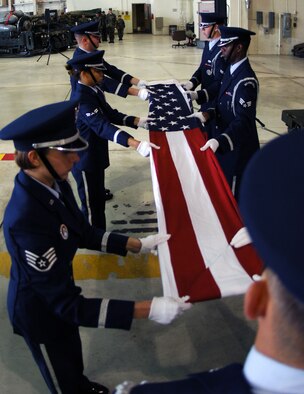 MINOT AIR FORCE BASE, N.D. -- Members of the base Honor Guard fold the U.S. flag in honor of servicemembers who have been captured as prisoners of war or are missing in action during a special retreat ceremony at Dock 7 Sept. 22. (U.S. Air Force photo by Airman First Class Joe Rivera)