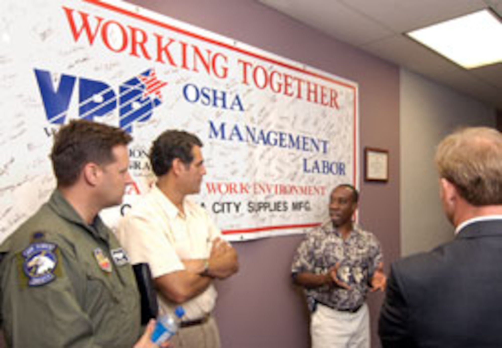 YUKON, Okla.— Tinker safety representatives traveled to Xerox to learn how that company implemented the VPP. Lt. Col. David Barker, Daniel Gamboa and Bill Barnes, far right, listen to Xerox’s safety manager, Gabriel John. (Air Force photo by Margo Wright)

