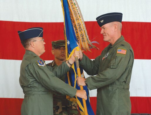 Brig. Gen. Blair Hansen, 9th Air Force vice commander, presents the 23rd Wing guidon to Col. Joe Callahan, 23rd Wing commander, while Chief Master Sgt. Michael Mazzi, 23rd Wing command chief, looks on during the 23rd Wing's re-designation ceremony. The ceremony culminated several recent changes to Moody’s wing, including the assumption of the 23rd Fighter Group at Pope Air Force Base, N.C., and Moody’s 820th Security Forces Group. (U.S. Air Force photo by Senior Airman Schelli Jones)