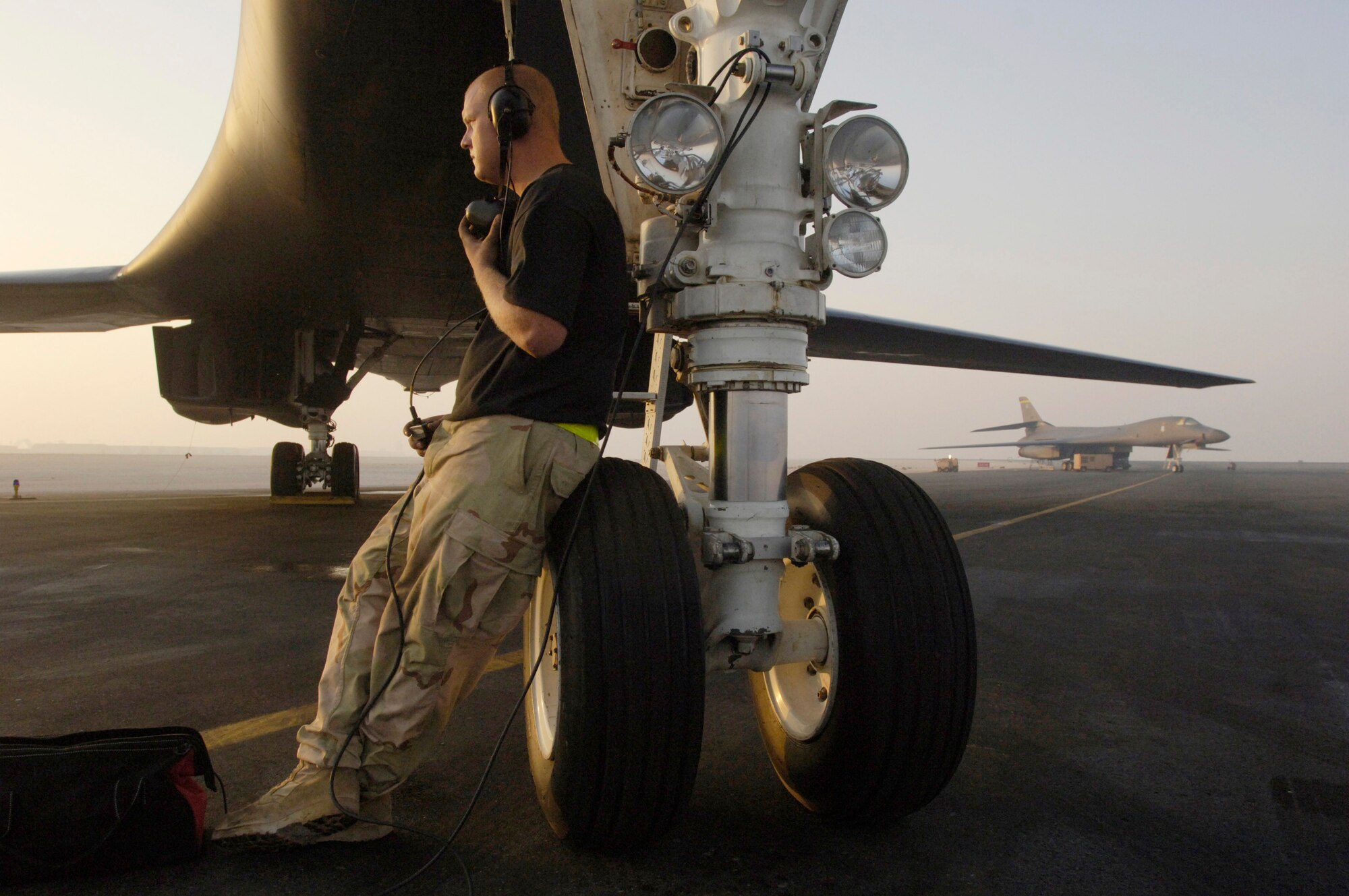 Senior Airman Phillip Larson runs through a preflight inspection next to a B-1 Lancer in Southwest Asia Sept. 28. The crew chief's tasks include observing the firing-up of four turbofan engines that expend a combined thrust of 120,000 pounds, enabling the long-range, multi-role bomber to fly at speeds exceeding 900 mph. Airman Larson is assigned to the 379th Aircraft Maintenance Squadron at a forward-operating base. (U.S. Air Force photo/Master Sgt. Scott Wagers) 
