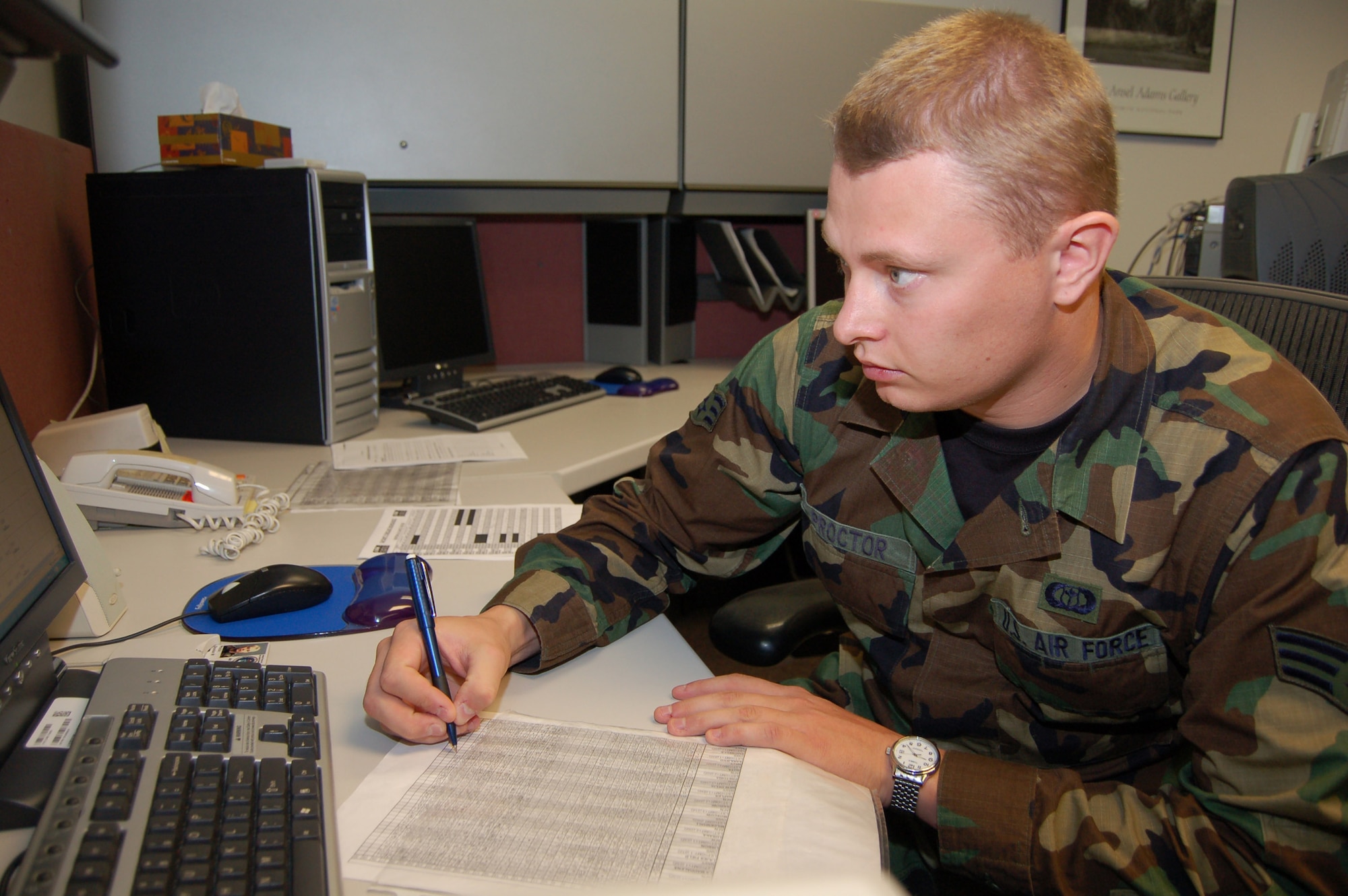 Senior Airman Brandon Proctor compares previous forecasts against actual weather recordings to quality-check formulas used to make the forecasts. He is a weather broadcast technician with the Air Force Weather Agency at Offutt Air Force Base, Neb. (U.S. Air Force photo/Staff Sgt. Shad Eidson)
