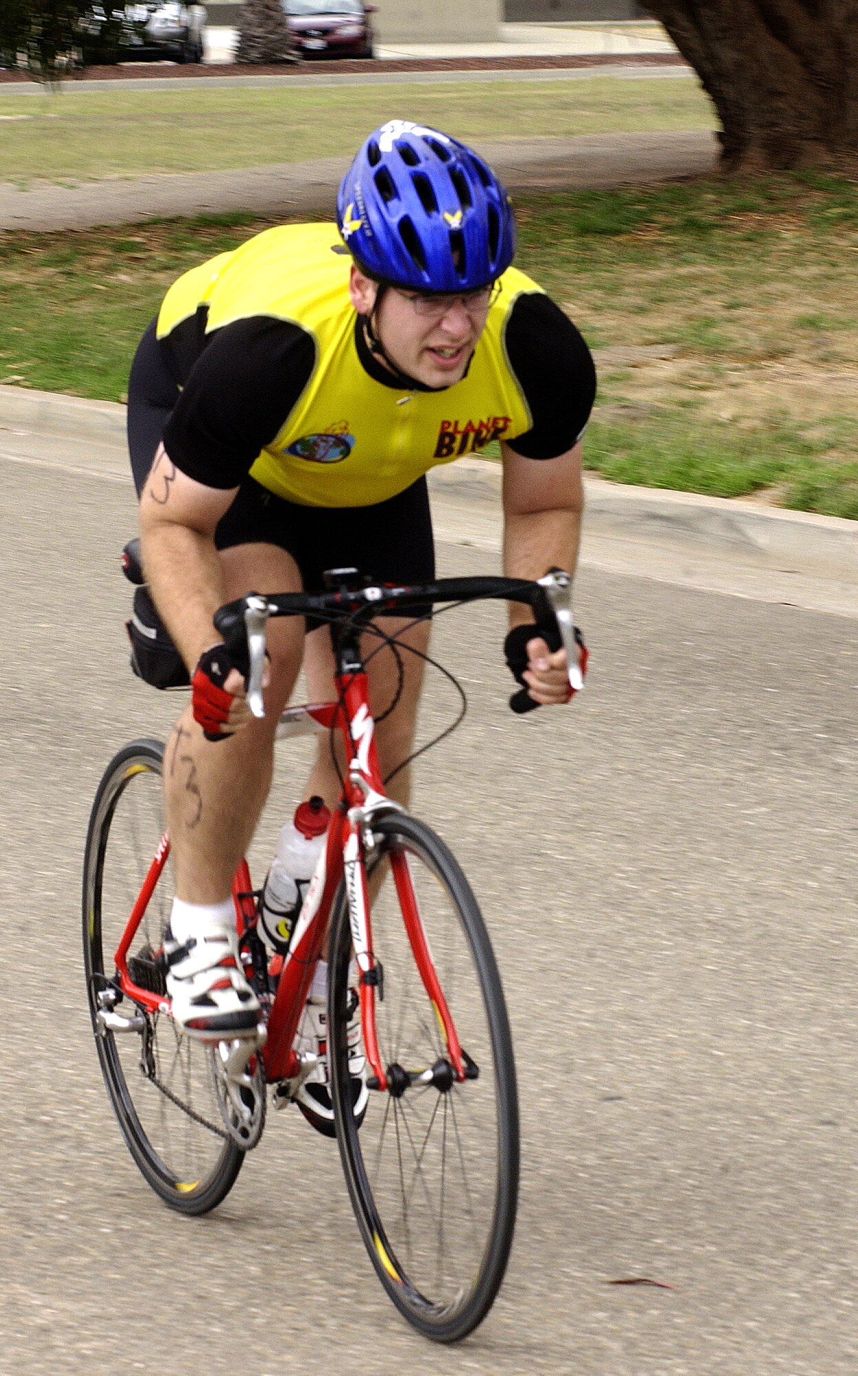Tech. Sgt. Travis Yates, 381st Training Support Squadron, approaches the finish line during the bike portion of the triathlon near the base track.  Biking was the second leg of the event.  Sergeant Yates’ team finished in fifth place overall with a final time of 1 hour, 9 minutes, and 50 seconds.