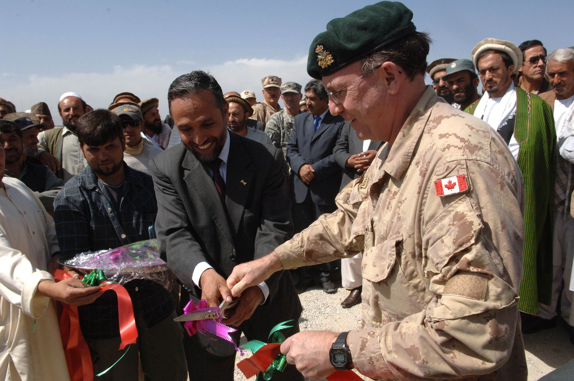 Canadian Brig. Gen. Daniel Pepin cuts the ribbon on the Kapisa road system project in Afghanistan Sept. 29. The $3 million project is the highest construction project ever awarded in the country. When completed, it will be the only province to have all districts and the capitol connected by roads. The general is the deputy commanding general for reconstruction efforts in Afghanistan (U.S. Air Force photo/Tech. Sgt. Joseph Kapinos)