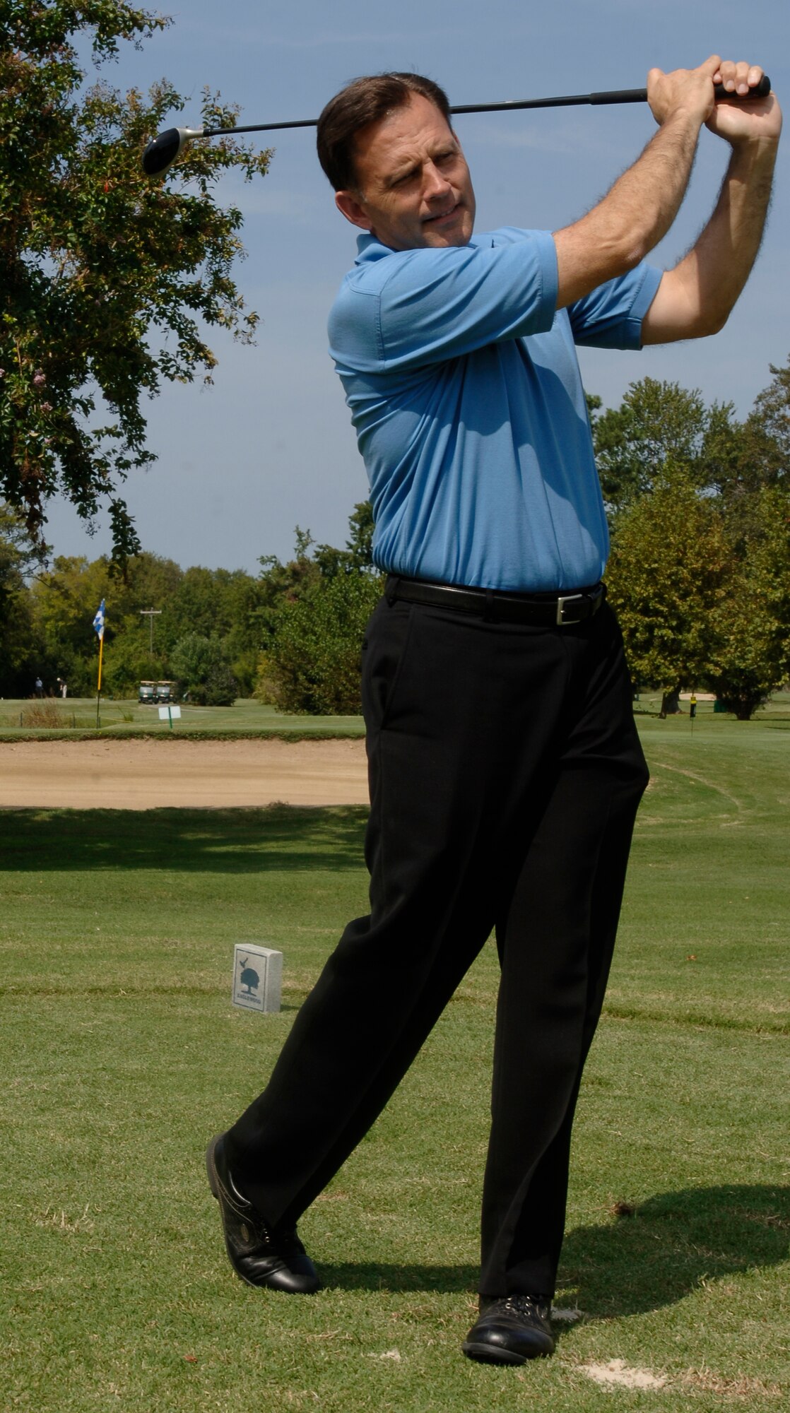 Maj. Gen. Jack Catton, Air Combat Command A8 director, takes a practice swing at the Langley Officers’ Spouses’ Club golf tournament fundraiser Sept. 22. (Photo by Airman 1st Class Christopher Ingersoll)