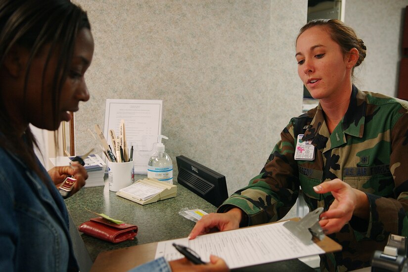 Airman Cortney Cassedy shows a patient what forms to fill out at the Bethel Clinic Monday. The Bethel Clinic officially reopened its doors Monday and welcomed patients in after more than a month of renovations. The Bethel Clinic and Langley Clinic at NASA will see retirees and dependents while the Blue Clinic in the Langley Hospital will see Active Duty members only. (Photo by Senior Airman DeLicha Germany)
