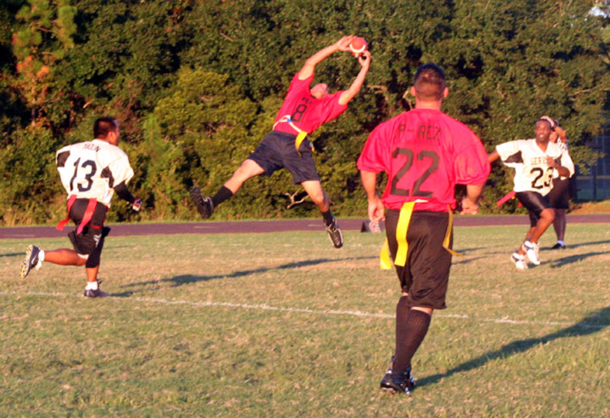 A 16th CMS POL player struggles to reign in a pass during their disheartening loss to the 16th SVS team here Sept. 25. A good defense and dominating offense helped SVS take an early lead in the game, which they never relinquished. (U.S. Air Force Photograph by Senior Airman James Dickens)