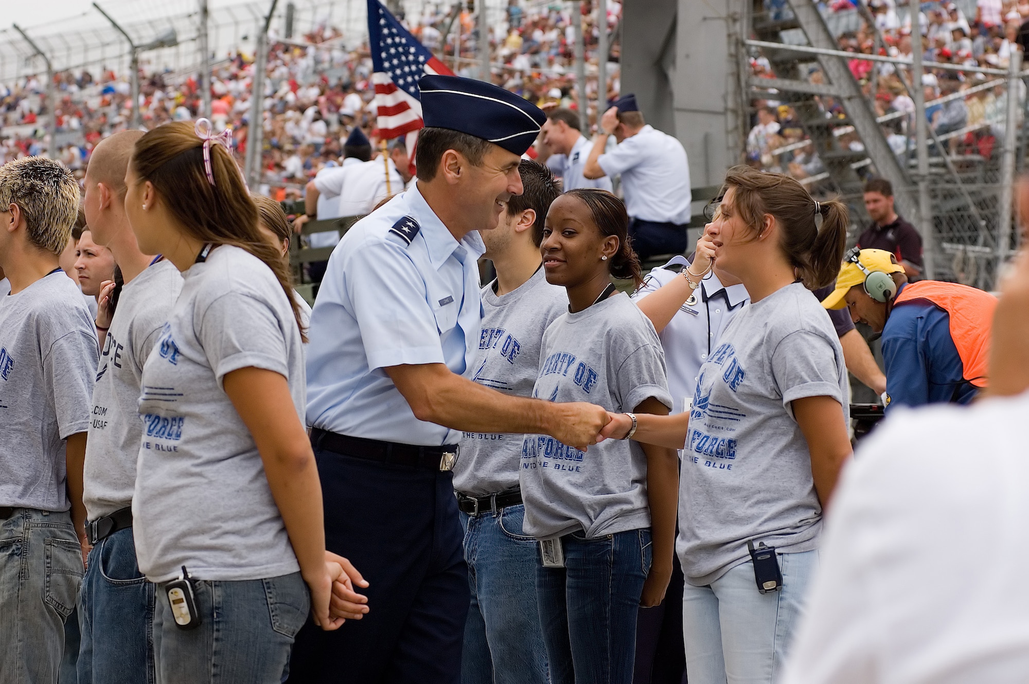 Maj. Gen. Raymond Johns Jr., Headquarters Air Force Director of Programs for the Office of the Deputy Chief of Staff for Strategic Plans and Programs in Washington, D.C., congratulates the Air Force’s newest recruits after issuing the oath of enlistment to them before the start of the Nextel Cup series race Sunday. The recruits are joining the Air Force through the Delayed Enlistment Program. Under the DEP, individuals going onto active duty, enlist first into the DEP. This is an actual enlistment into the inactive Reserves, with an agreement to report for active duty – to attend basic military training – at a specific time in the future. (U.S. Air Force photo/Roland Balik)