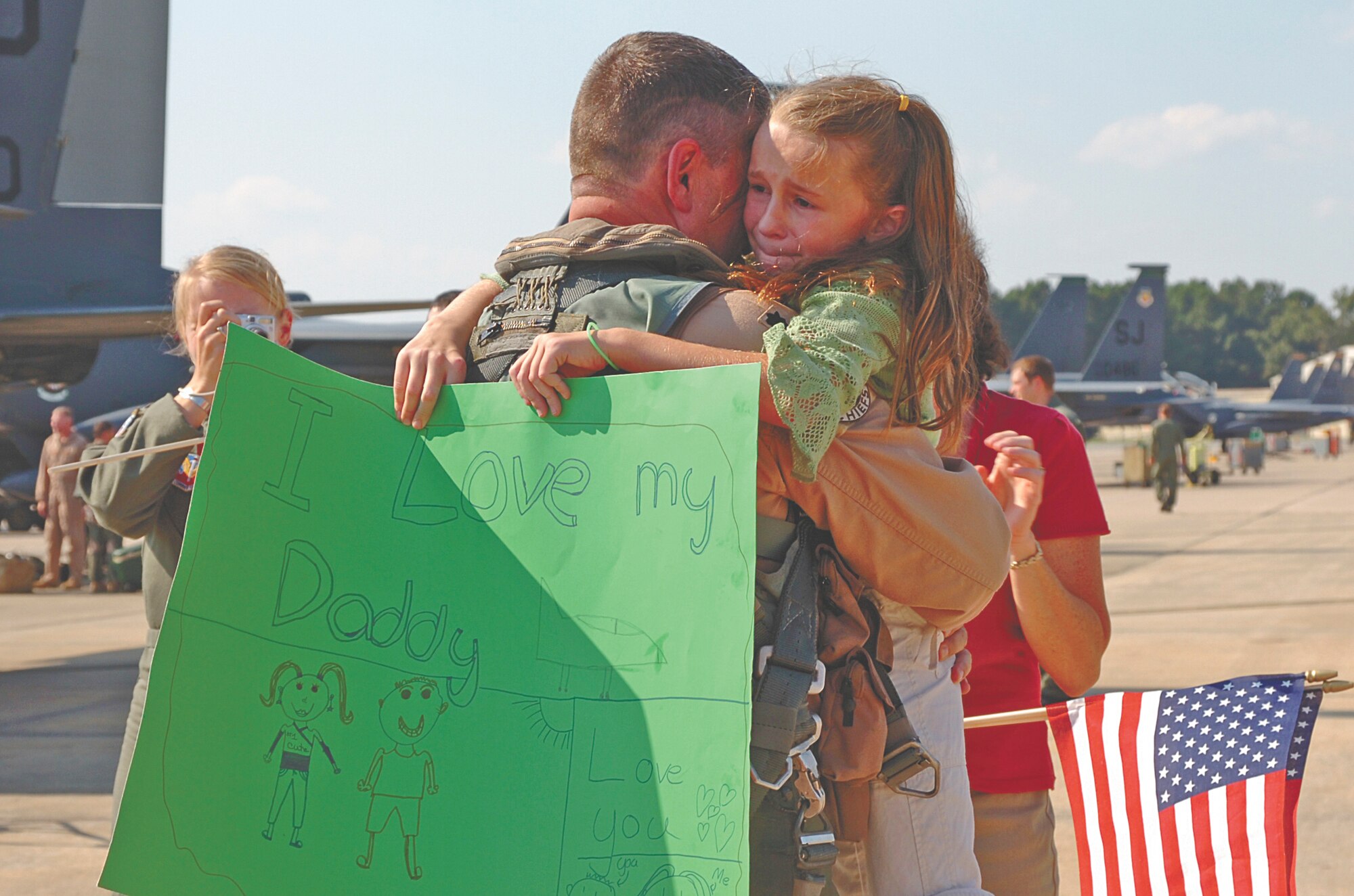 Lieutenant Col. Todd Boyd, 335th Fighter Squadron commander, embraces his daughter, Madison, during the first wave of returns of the deployed Chiefs Wednesday afternoon. Several family, squadron and community members welcomed the Chiefs with waving flags.  The Chiefs return home after serving more than four months in Southwest Asia in support of Operation Iraqi Freedom. Our Airmen are expeditionary warriors who are trained and ready to deploy in support of the mission. The Chiefs proved the F-15E Strike Eagle continues to provide matchless combat power anytime, anywhere. (Photo by Senior Airman Micky Bazaldua)