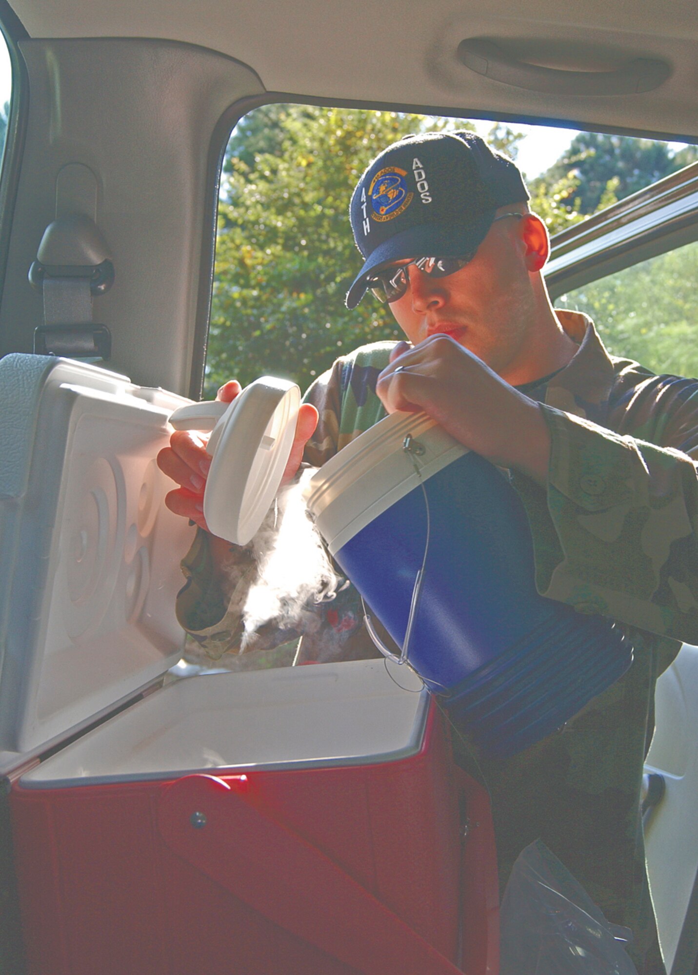 Staff Sgt. Aaron Geyer, public health technician, prepares dry ice to place in a light trap that attracts mosquitoes. Dry ice emits carbon dioxide when it evaporates, attracting female mosquitoes.  (Photo by Staff Sgt. Les Waters)                            