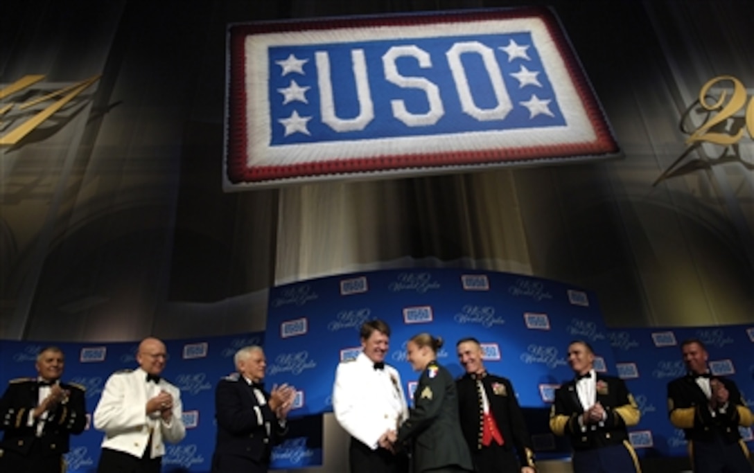 Army Sgt. Leigh Hester is congratulated by numerous senior defense leaders for receiving the 2006 USO Servicemember of the Year Award in Washington, D.C., Sept. 28, 2006. Hester is the first woman since World War II to receive the Silver Star for Valor in Combat.