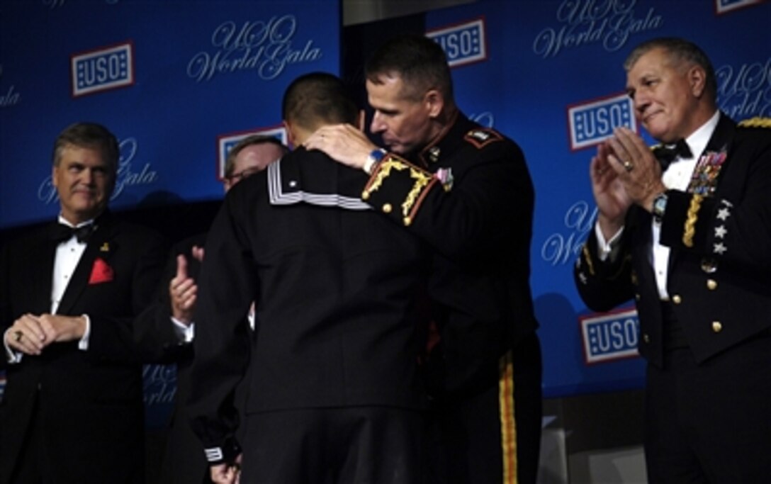 Chairman of the Joint Chiefs of Staff U.S. Marine Corps Gen. Peter Pace congratulates Corpsman Nathaniel Leoncio, while he is being presented the 2006 USO Servicemember of the Year award at the 65th USO World Gala in Washington, D.C, Sept. 28, 2006. 