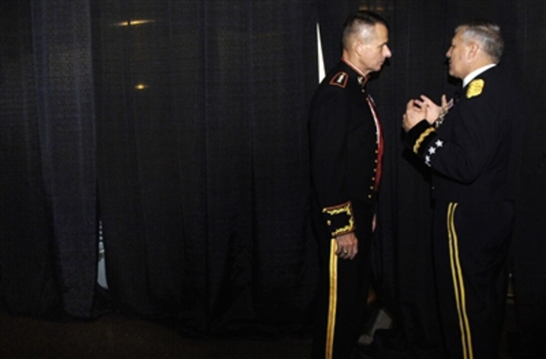 U.S. Marine Corps Gen. Peter Pace, chairman of the Joint Chiefs of Staff, listens to U.S. Army Gen. Dick Cody, vice chief of staff of the Army, prior to being introduced at the 65th Annual World Gala in Washington, D.C., Sept. 28, 2006. 