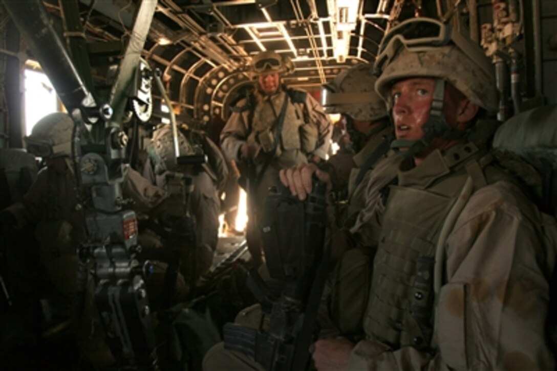 U.S. Marines with the Helicopter Support Team pile into a CH-53E Super Stallion after successfully completing the recovery of an immobilized UH-60 Blackhawk helicopter in the Al Anbar Province of Iraq, Sept. 27, 2006. 