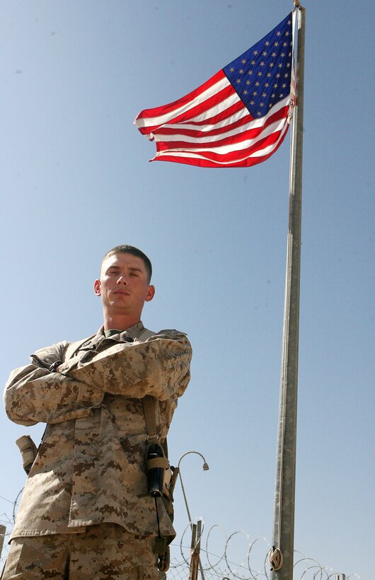 Staff Sgt. James L. Aultman, 27, chief of training for Combat Logistics Battalion 1, 1st Marine Logistics Group (Fwd), stands under the National Emblem. The Sylvester, Ga., native was awarded the Capital One Marine Security Guard of the Year for his efforts during his three year tour with Alpha and Bravo Company, Marine Security Guard Battalion, 4th Marine Expeditionary Force. ?From where I came from, I would have never expected this? Aultman said. ?Coming from nothing and going so far with achieving so much.?