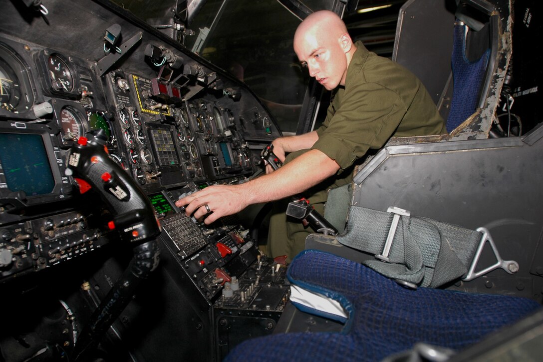 ABOARD USS BOXER (Oct. 2, 2006)--Marine Sgt. Josh Eogitch, Nashville, Tennessee,assigned to the Aviation Combat Element (ACE) Maintenance team of the 15th Marine Expeditionary Unit/Special Operations Capable (MEU/SOC) deployed aboard USS Boxer (LHD 4) inspects an SH-53 helicopter's pilot and navigation controls.  The Maintenance Team performs checks on aircraft to ensure flight readiness and safety.  Boxer is the flag ship for the Boxer Expeditionary Strike Group (BOXESG), operating out of San Diego, Calif.; which is reporting operationally to Commander, Expeditionary Strike Group (ESG) 7/ Task Force (CTF) 76, the Navy's only forward-deployed amphibious task force.  U.S. Navy photo by Mass Communication Specialist Seaman Derek R. Sanchez. (RELEASED)