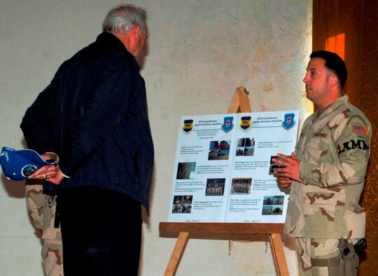 ALI BASE, Iraq -- Staff Sgt. Joseph Bozsoki, a Kadena munitions Airman, explains the munitions mission at Ali Base, Iraq, March 28 to Secretary of the Air Force Michael Wynne.  Secretary Wynne’s visit was part of a two-base tour of Air Force units in Iraq. (Air Force/Master Sgt. James A. Rush)