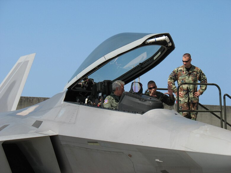 KADENA AIR BASE, Japan -- Alex Trebek, host of the Jeopardy game show, gets a close-up look at the controls of an F-22 stealth fighter March 31 during a Jeopardy USO tour to Japan.  Explaining the finer points of the F-22 are Staff Sgt. Michael Mauriello (left) and Tech. Sgt. Chris McEwan.  They are both deployed here with the 27th Fighter Squadron from Langley Air Force Base, Va., on the F-22's first overseas deployment.  During the Jeopardy show's two-day trip to Kadena, Mr. Trebek and show staff also toured a KC-135 Stratotanker, an E-3 AWACS (Airborne Warning and Control System), an F-15C fighter, and an HH-60 helicopter. Kadena residents were allowed to try-out to be contestants on Jeopardy, as well.  (Air Force/Senior Master Sgt. Kenneth Fidler)